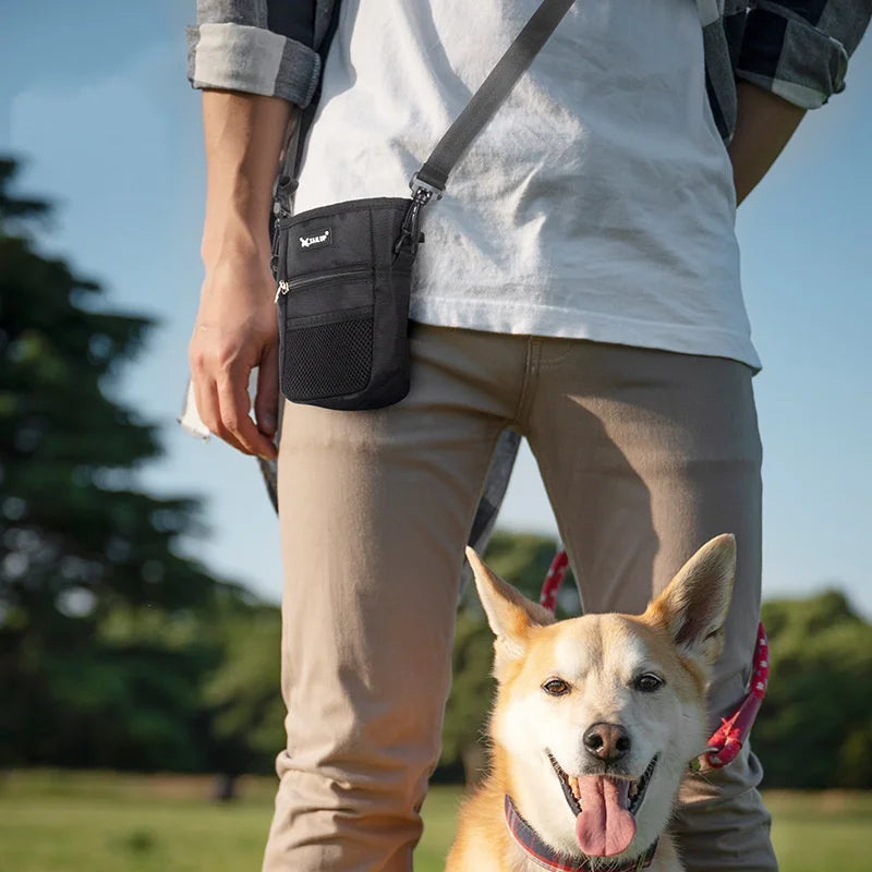 Black pet training treat pouch worn as a crossbody bag for easy dog obedience and agility snack rewards.