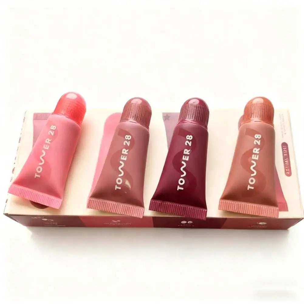 Tower 28 4-piece lip jelly set: hydrating tinted lip glosses in pink, mauve, berry, and nude shades for mirror shine.