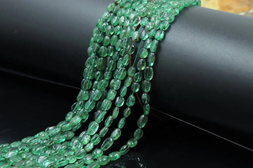 Green oval beads strand with small drilled holes, glossy and faceted look