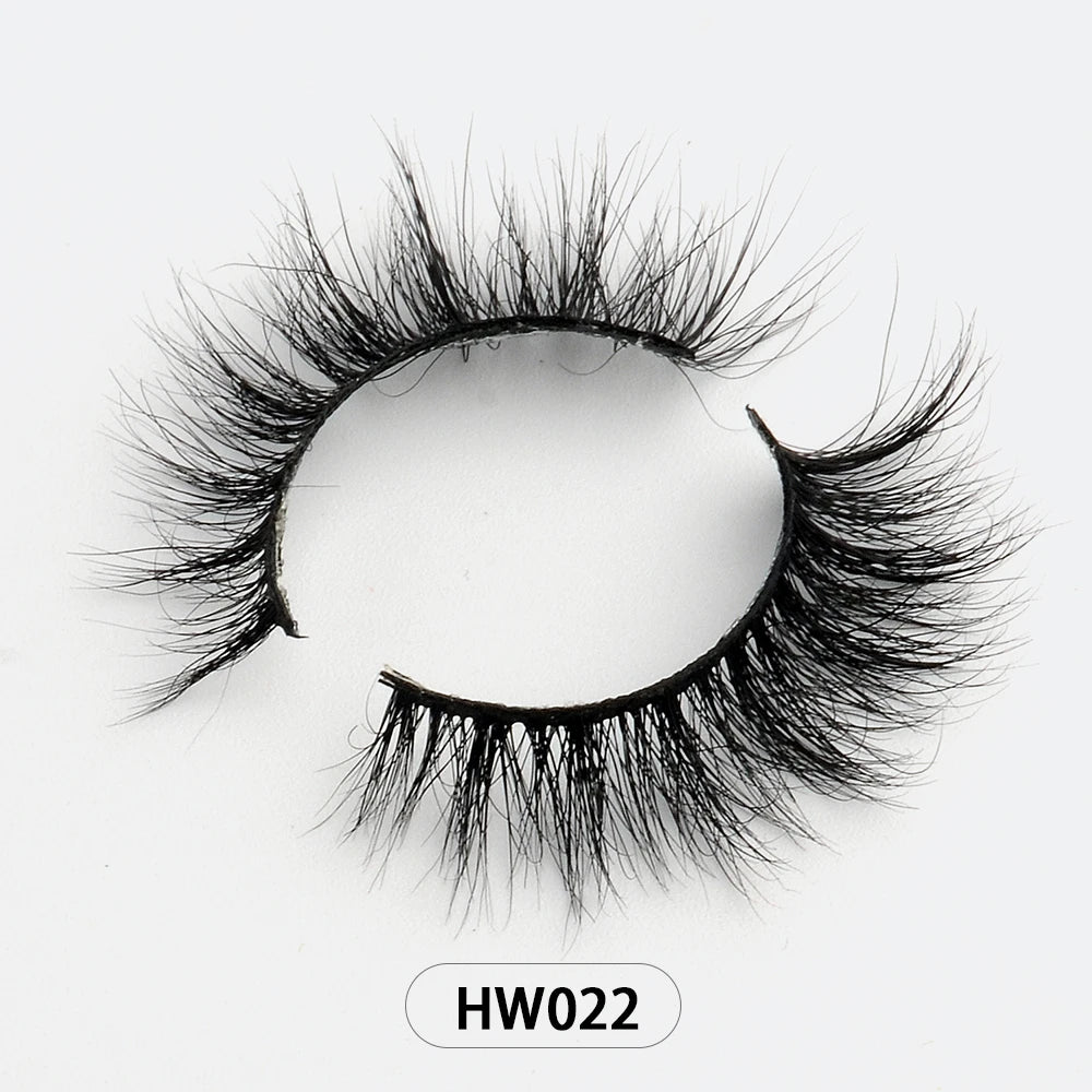 A pair of wispy, black 3D mink false eyelashes with a flexible band, labeled HW022, on a plain white background.