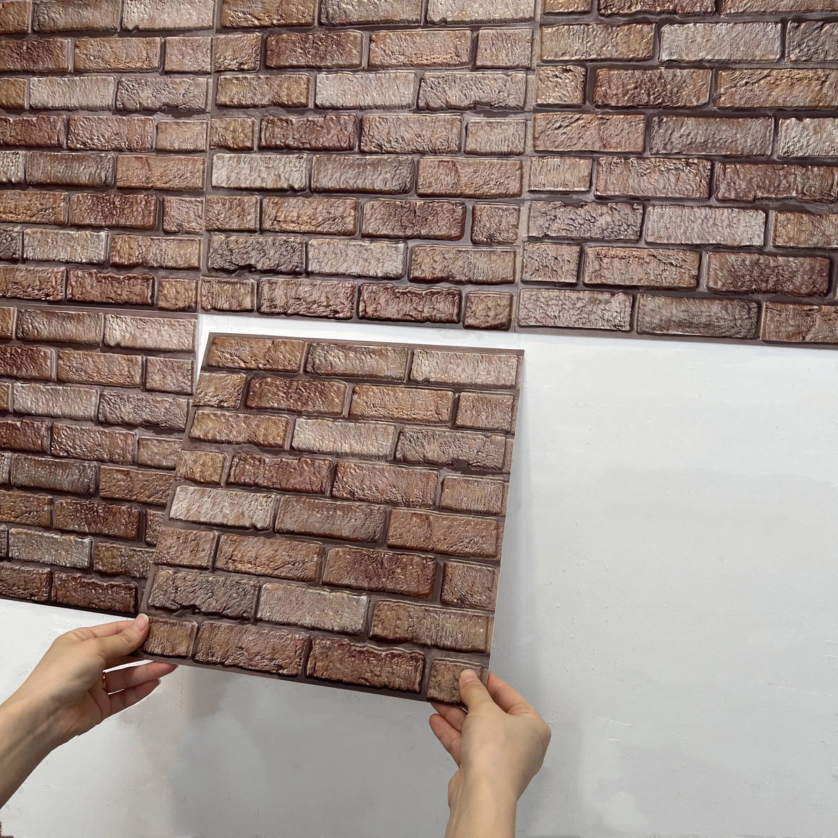 Peel-and-stick backsplash tile sheet with faux brick pattern in dark brown and beige
