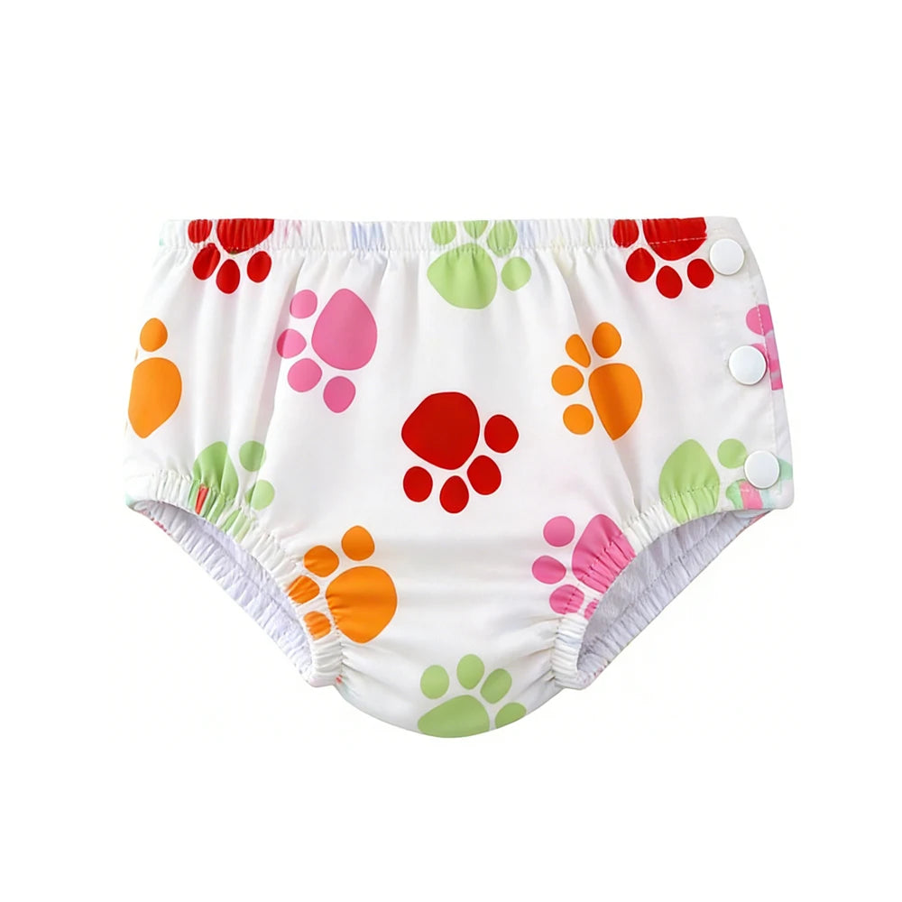 Reusable baby swim diaper with colorful paw print design and snap-side closure for easy changing.