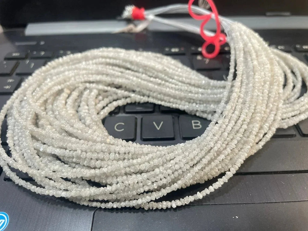 White raw diamond bead strand, 2–3mm beads with light sparkle, looped on card