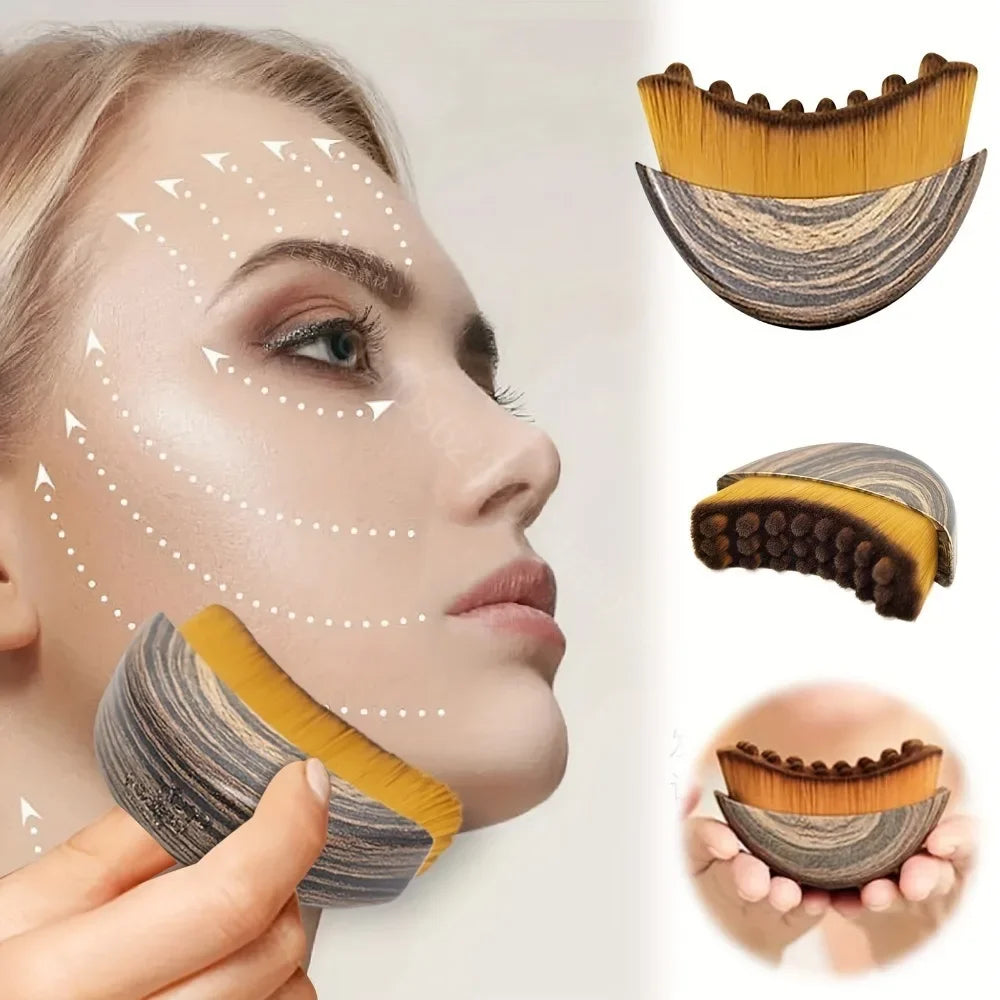Crescent-shaped facial massage brush with wood-grain handle and soft yellow bristles for contouring and lifting skin.