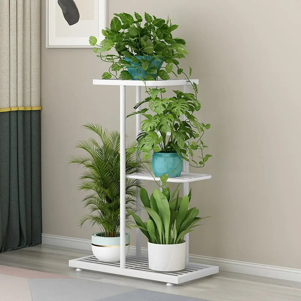 Multi-layer plant display shelf with white frame and round tiers, holding several potted plants