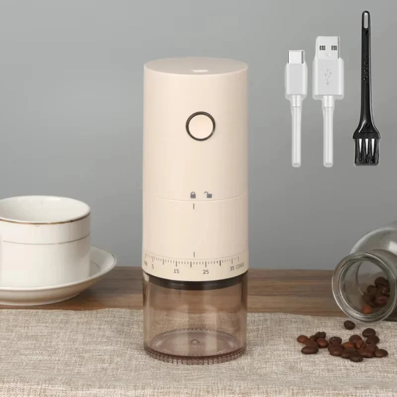 Beige portable electric coffee grinder with USB-C charging, adjustable grind dial, and clear grounds collection cup.
