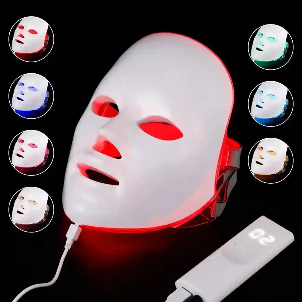 White LED light therapy facial mask with a digital remote and multiple color settings, isolated on a black background.