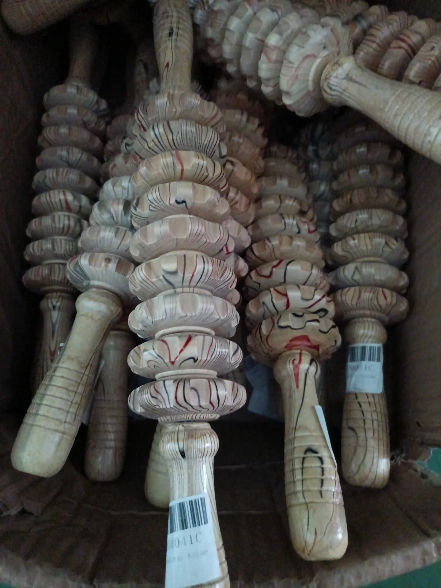 Wooden handheld massage rollers with multi-grooved circular beads, used for lymphatic drainage and muscle relief.