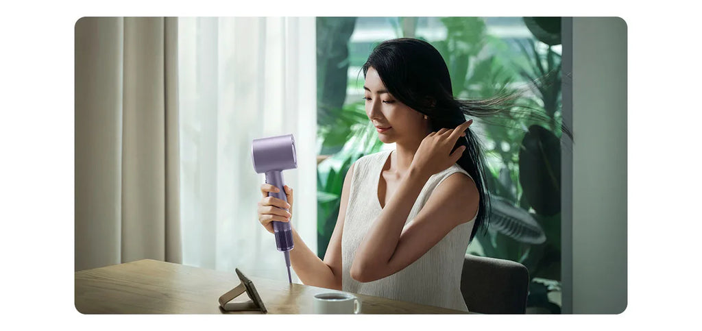 Woman using purple MIJIA H701 high-speed water ion hair dryer for professional, quick-dry hair care at home.
