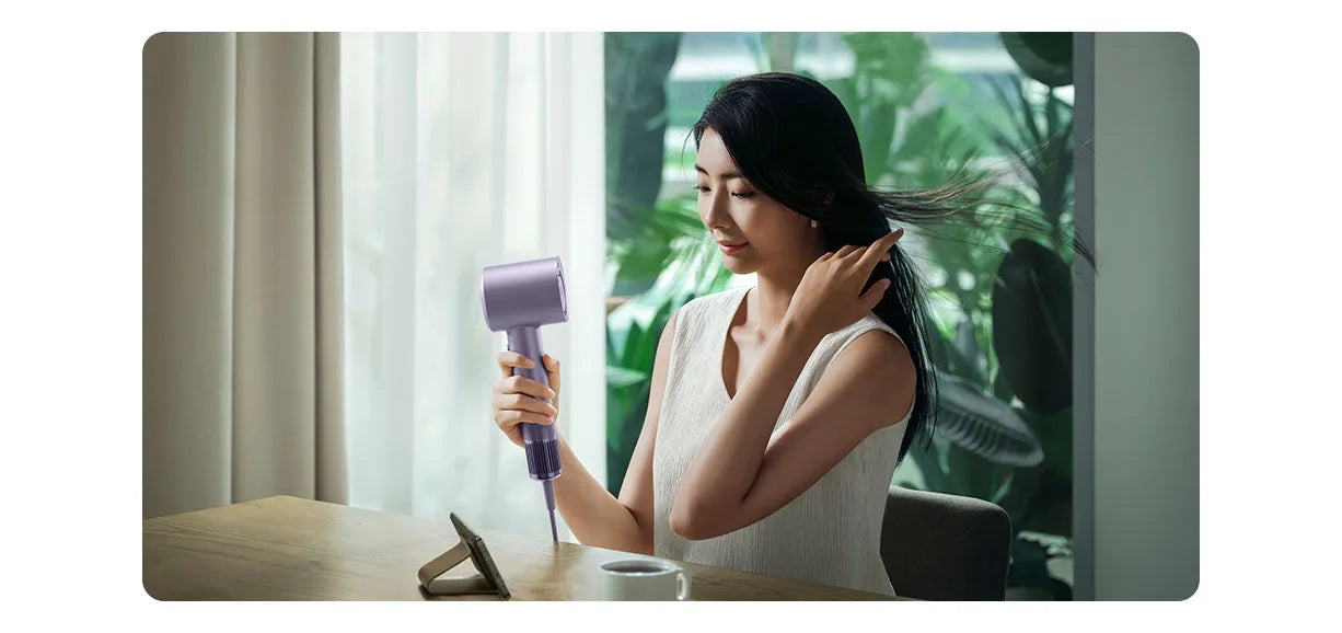 Woman using purple MIJIA H701 high-speed water ion hair dryer for professional, quick-dry hair care at home.