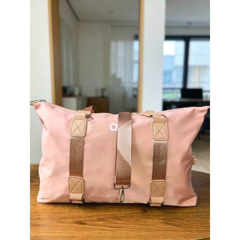 Waterproof yoga gym crossbody bag in light pink with webbing crossbody strap and clips