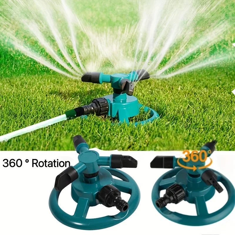 Teal rotating lawn sprinkler head creating wide fan water spray across grass