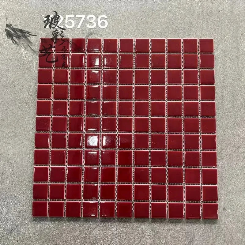 Red ceramic mosaic tile sheet with small square tiles and dark grout lines