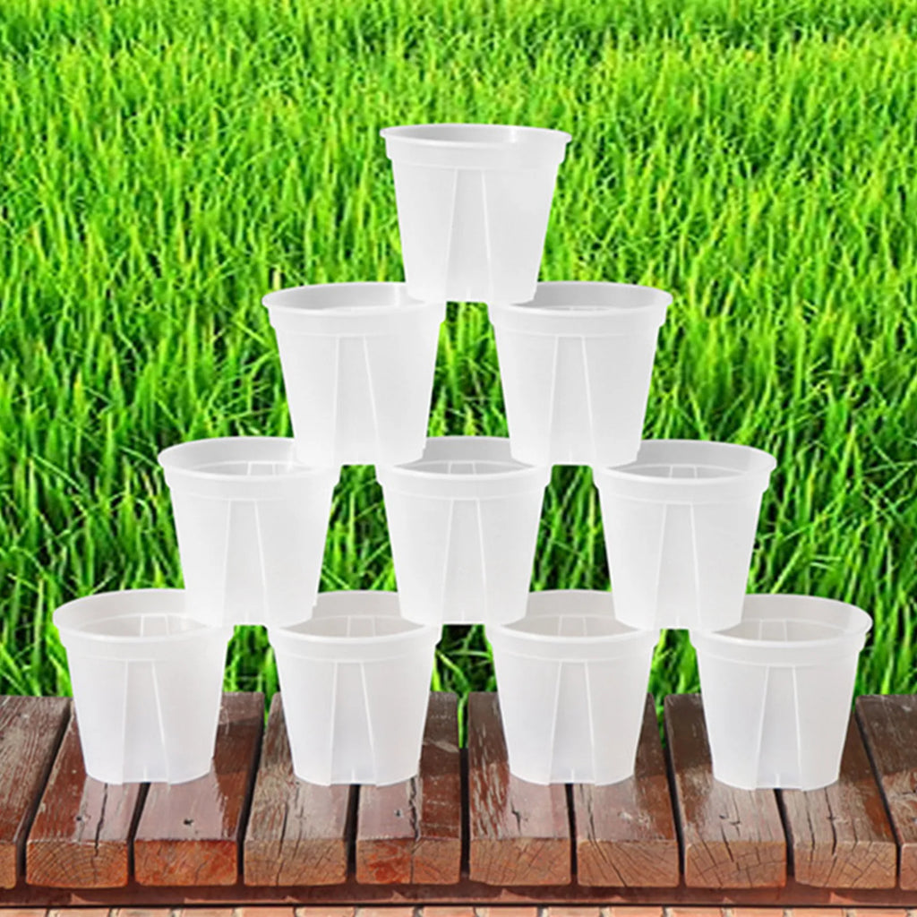 Cluster of white round planters standing on a wooden patio