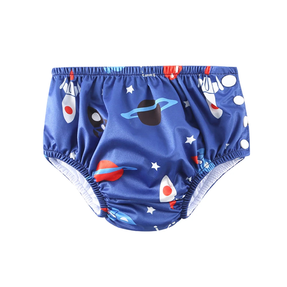Reusable baby swim diaper in blue with rocket ship and planet print, featuring side snap closures.