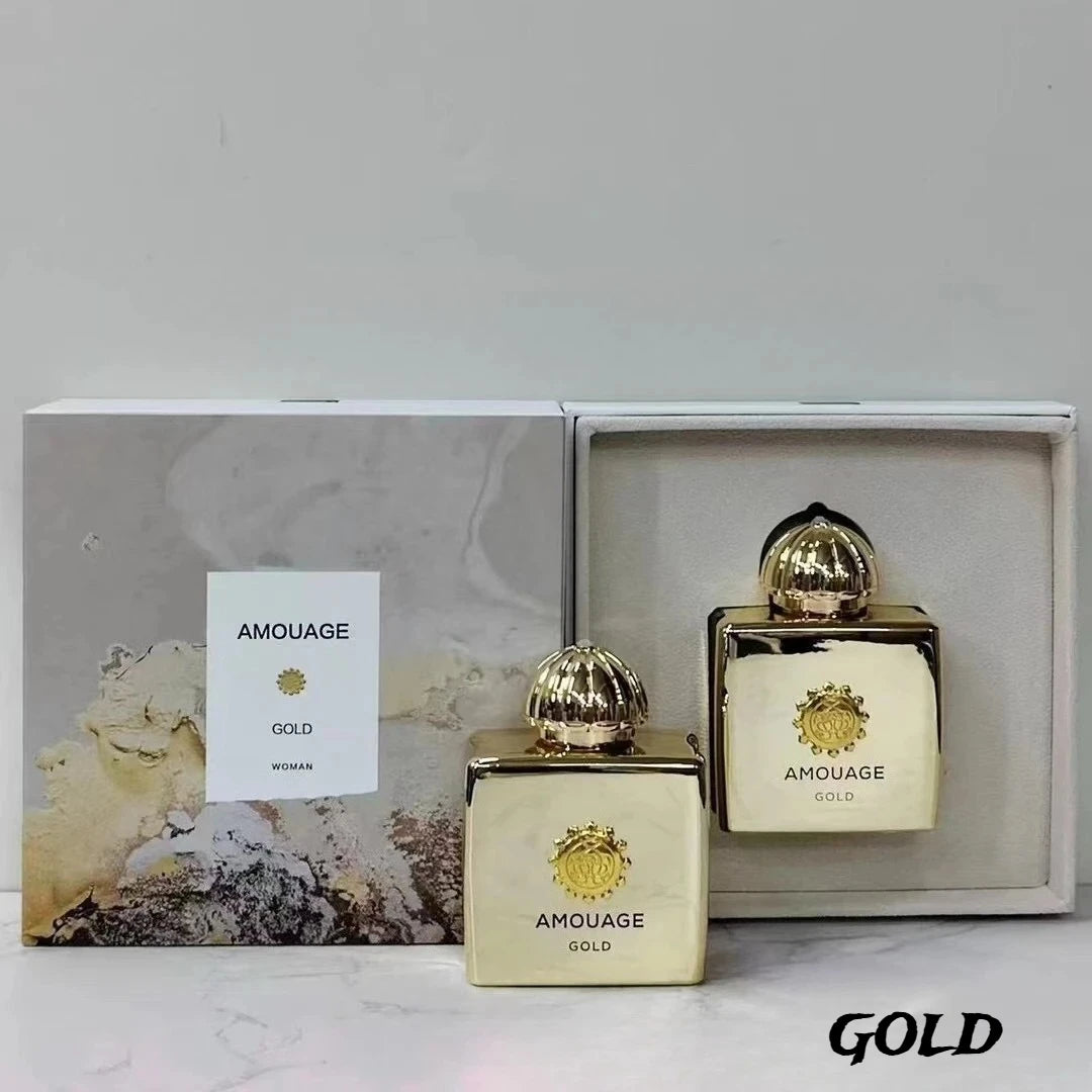 Two gold, square perfume bottles with dome caps, displayed with a marbled patterned box for women's fragrance.