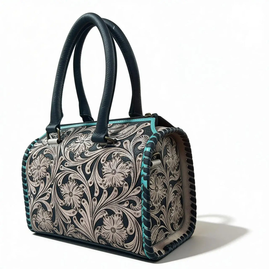 Luxury teal and black genuine leather mini duffel trunk with intricate floral tooling and double handles.