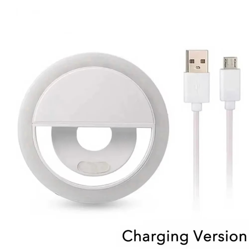 White circular clip-on LED selfie light with a USB charging cable for phone photography lighting.