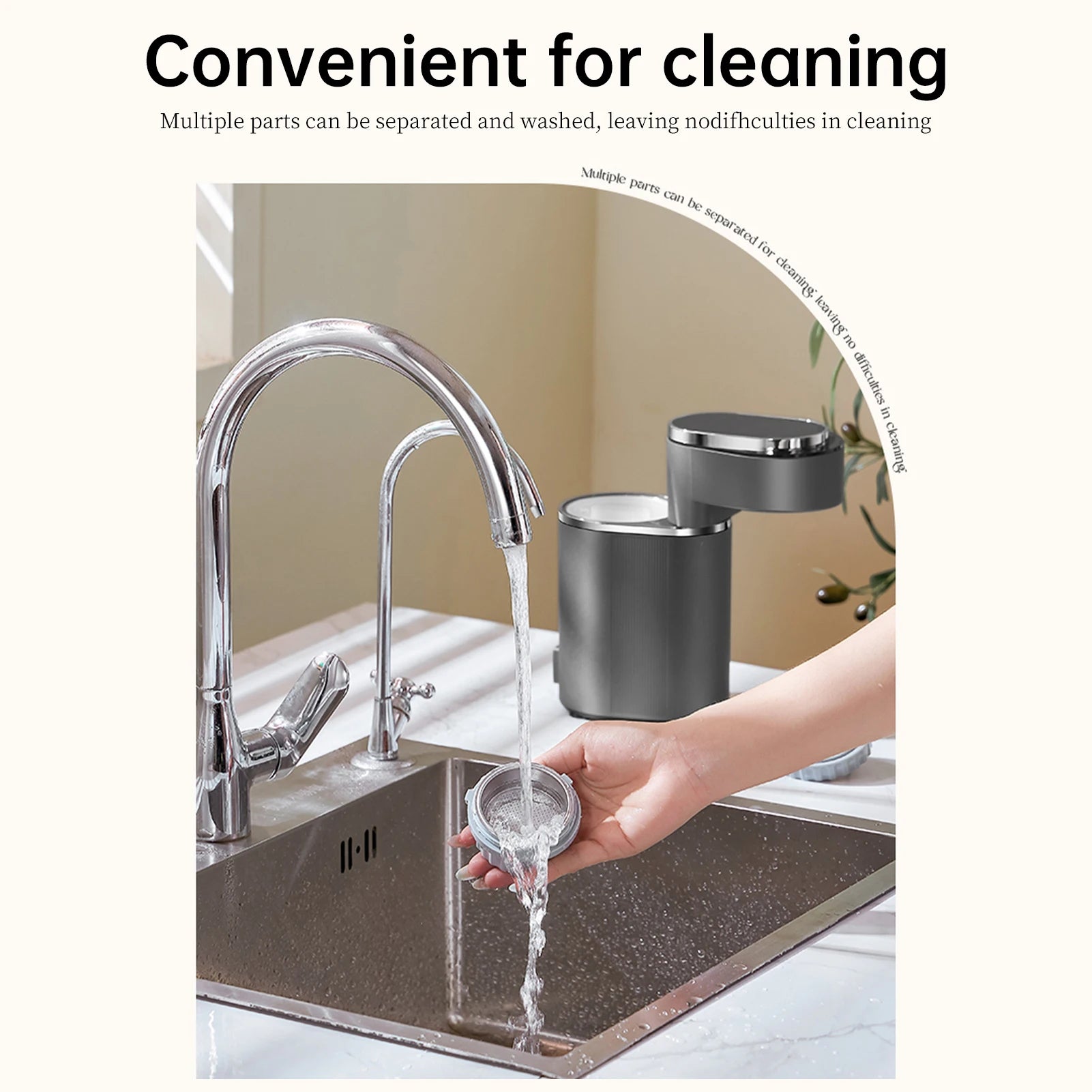 Hand rinsing a detachable metal mesh filter from a modern gray portable coffee maker in a kitchen sink.