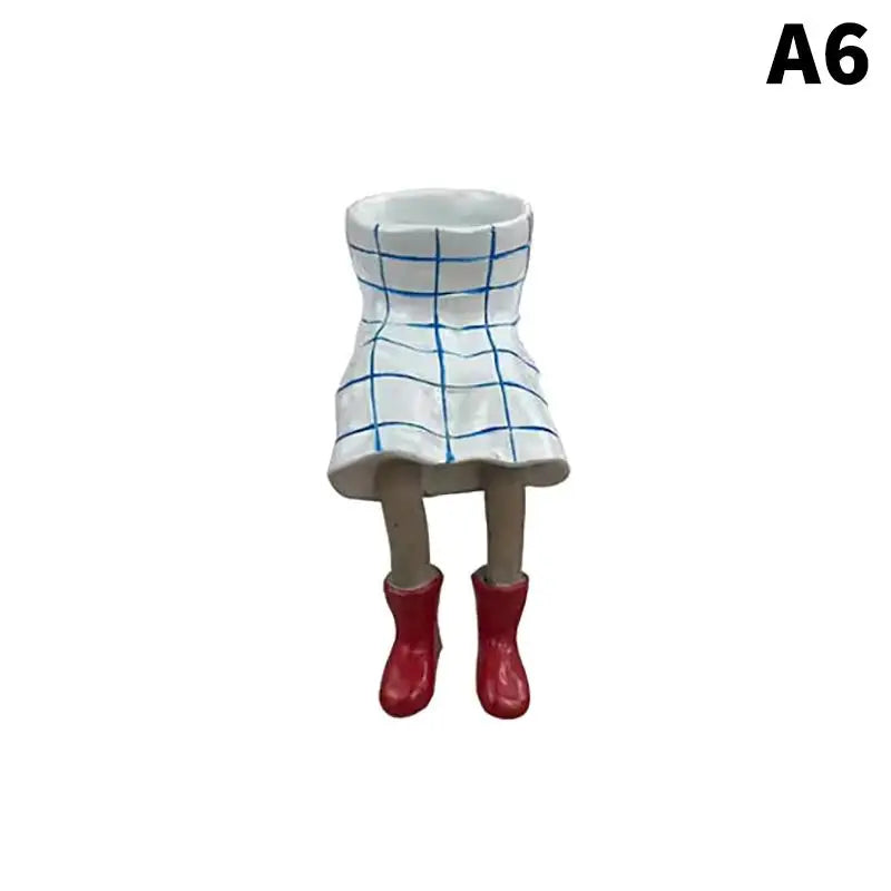 Resin leggy planter figurine with white pot and blue grid lines, red boots