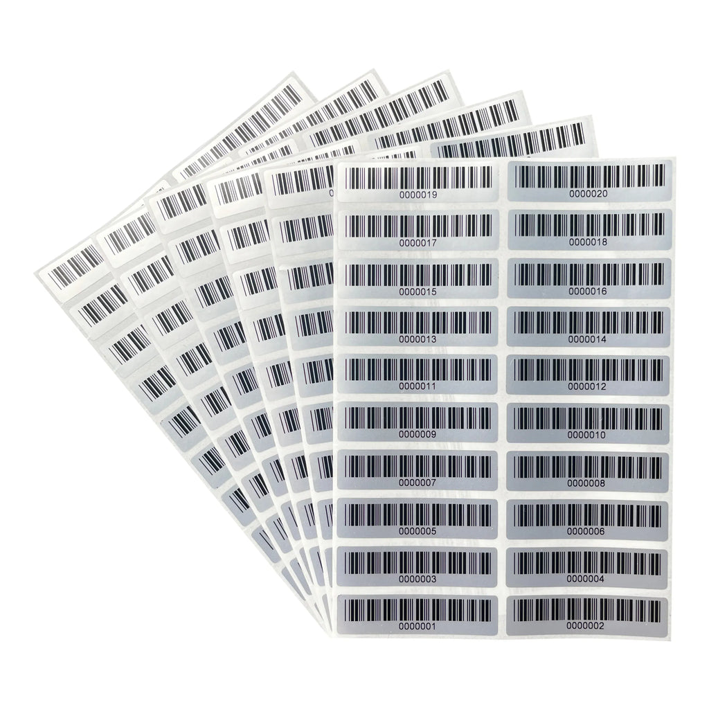 Matte silver PET barcode asset labels sheet, multiple rectangular labels in angled stack
