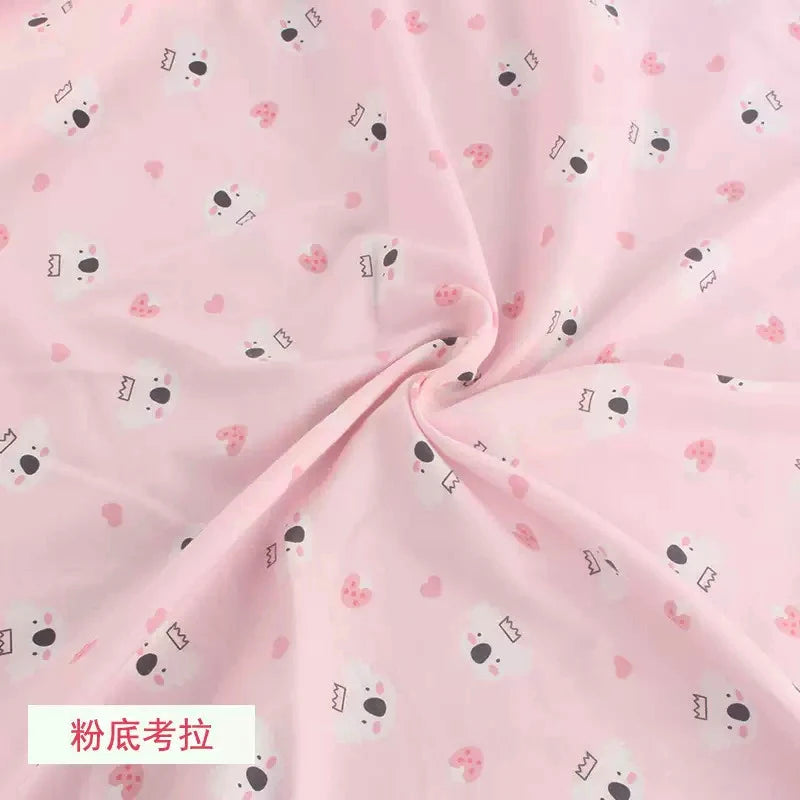 Tidesmit soft pink knit jersey fabric featuring a repeating pattern of cute koala faces and small pink hearts.