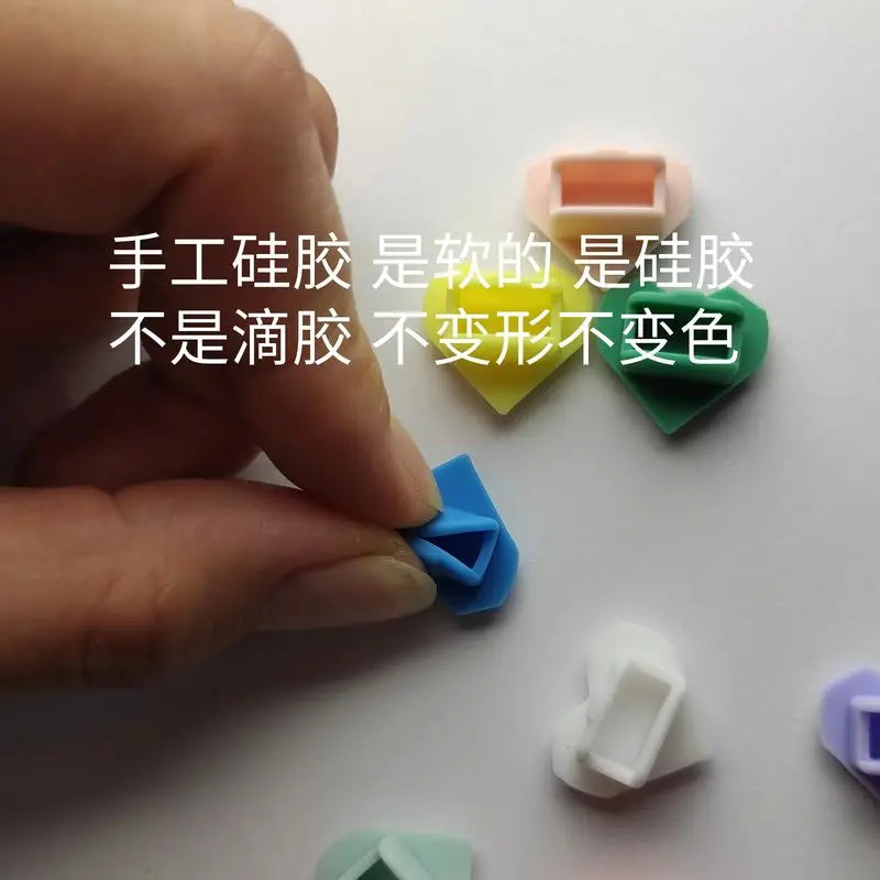 Colorful silicone heart dust plugs for Tamagotchi Uni, soft protective covers to keep electronic pet ports clean.