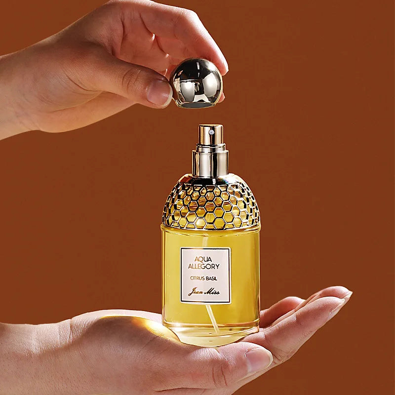 Jean Miss Aqua Allegory Citrus Basil EDT, 100ml floral perfume in a gold honeycomb bottle with round cap.