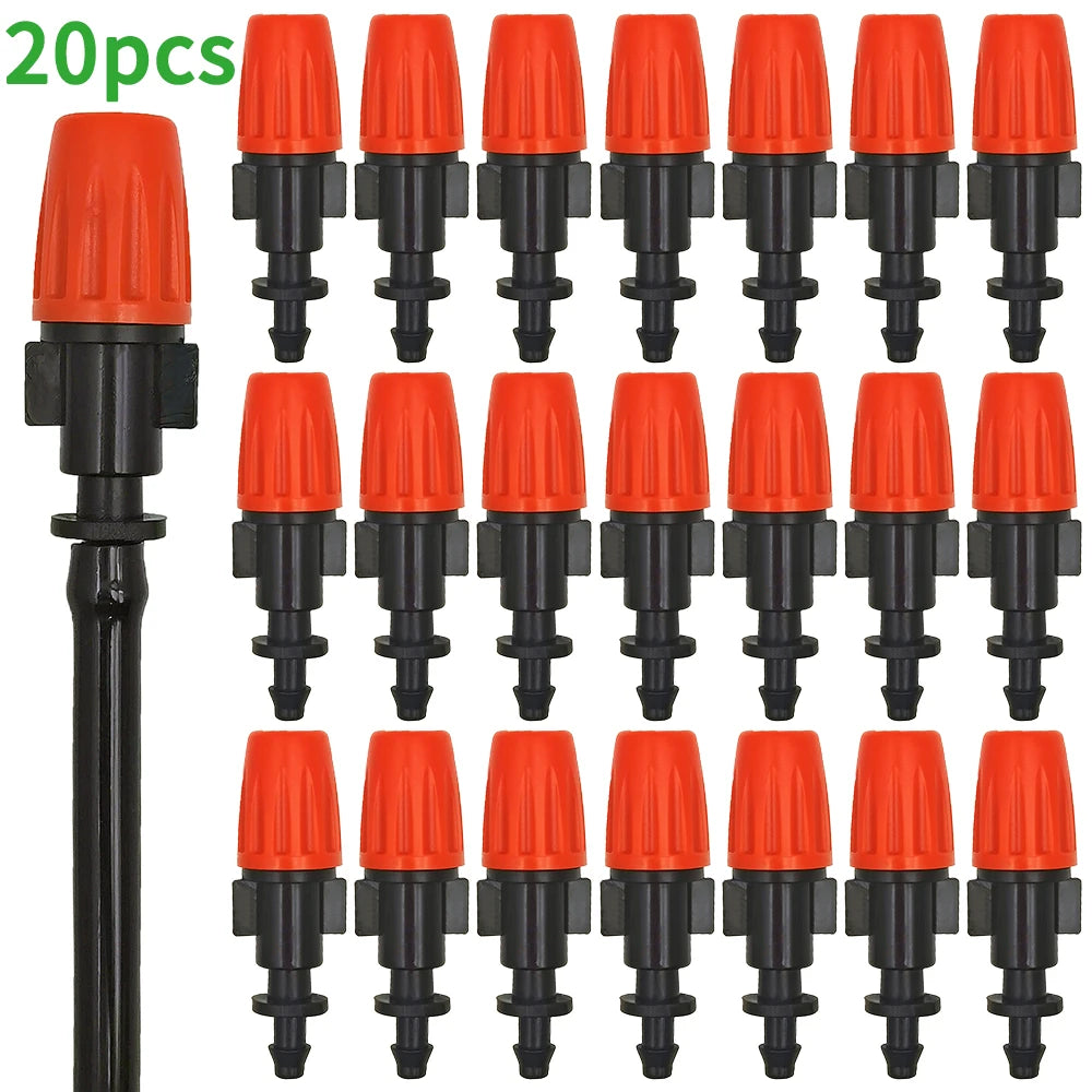 Orange and black drip emitters with barbed hose outlets on a bundled manifold