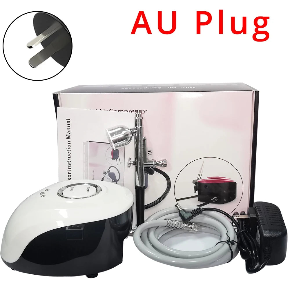 Portable airbrush compressor kit with white and black unit, air hose, chrome airbrush gun, and an AU plug power adapter.