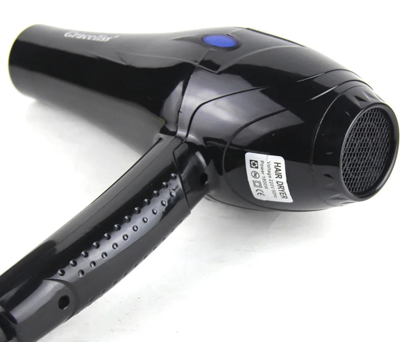 Glossy black 1800W professional hair dryer with textured handle, blue button, and rear air intake mesh.