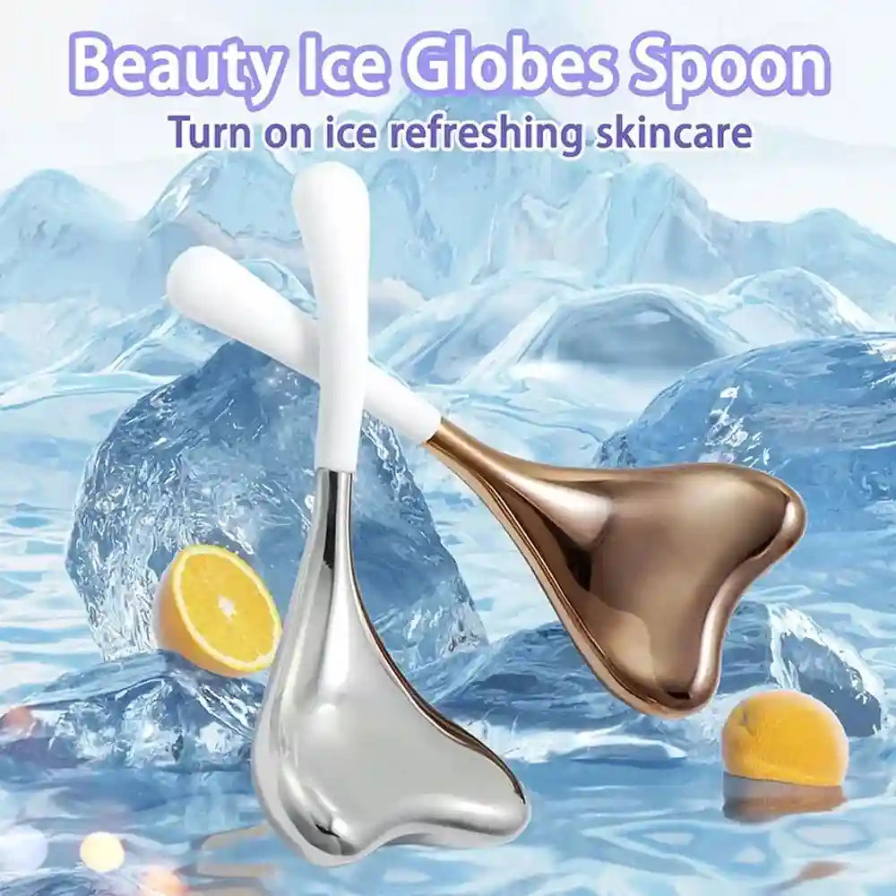 Two heart-shaped metal facial massage tools with white handles against an icy background with lemon slices.
