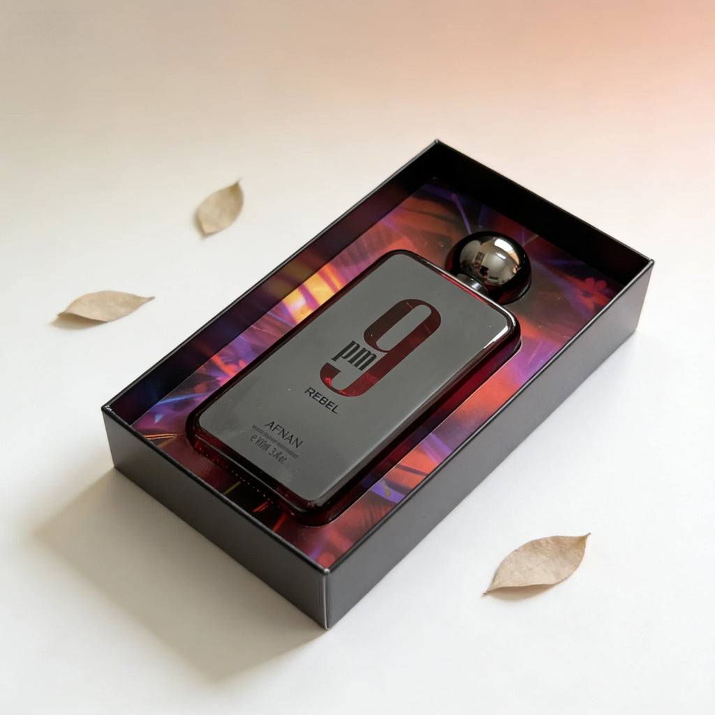 Afnan 9pm Rebel EDP for men: 3.4oz woody oud fragrance in a sleek rectangular bottle with a metallic round cap.
