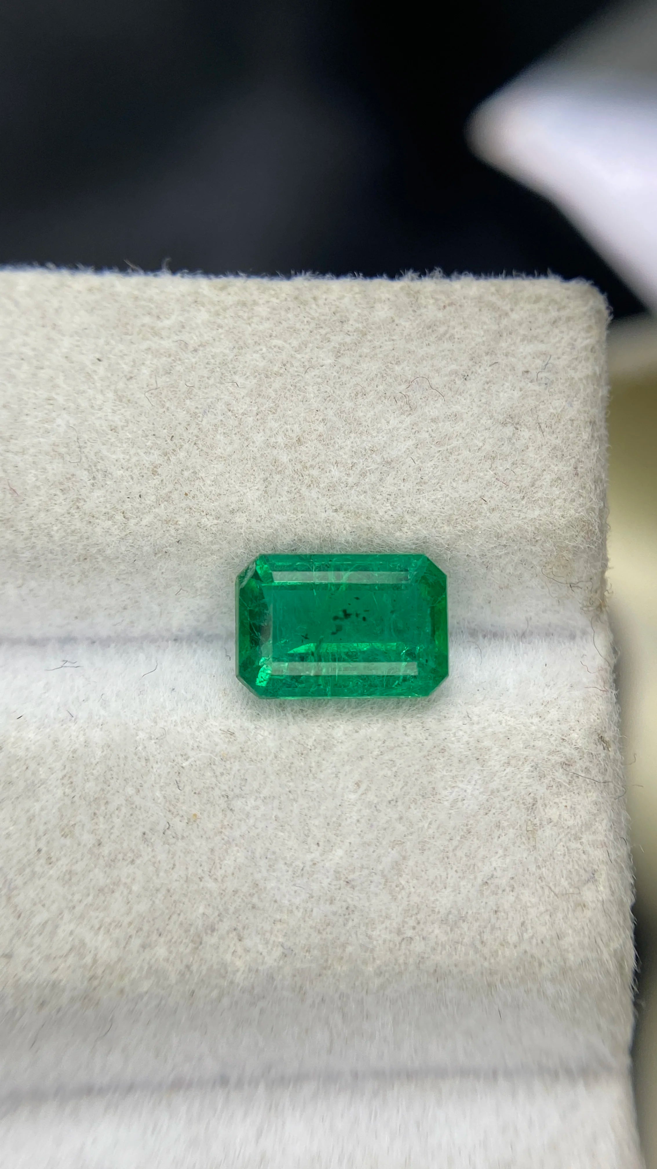 Green emerald-cut gemstone with octagon facets, loose natural stone for jewelry making.