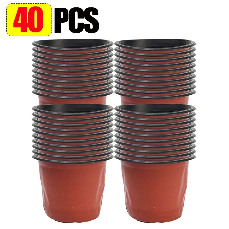 Set of red plastic nursery pots with black rims, stacked four for seedlings