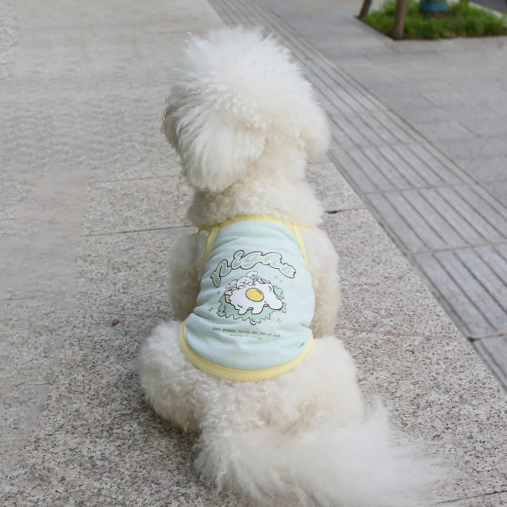 Small dog wearing a breathable mint green ice silk cooling vest for summer, featuring a cute egg graphic print.