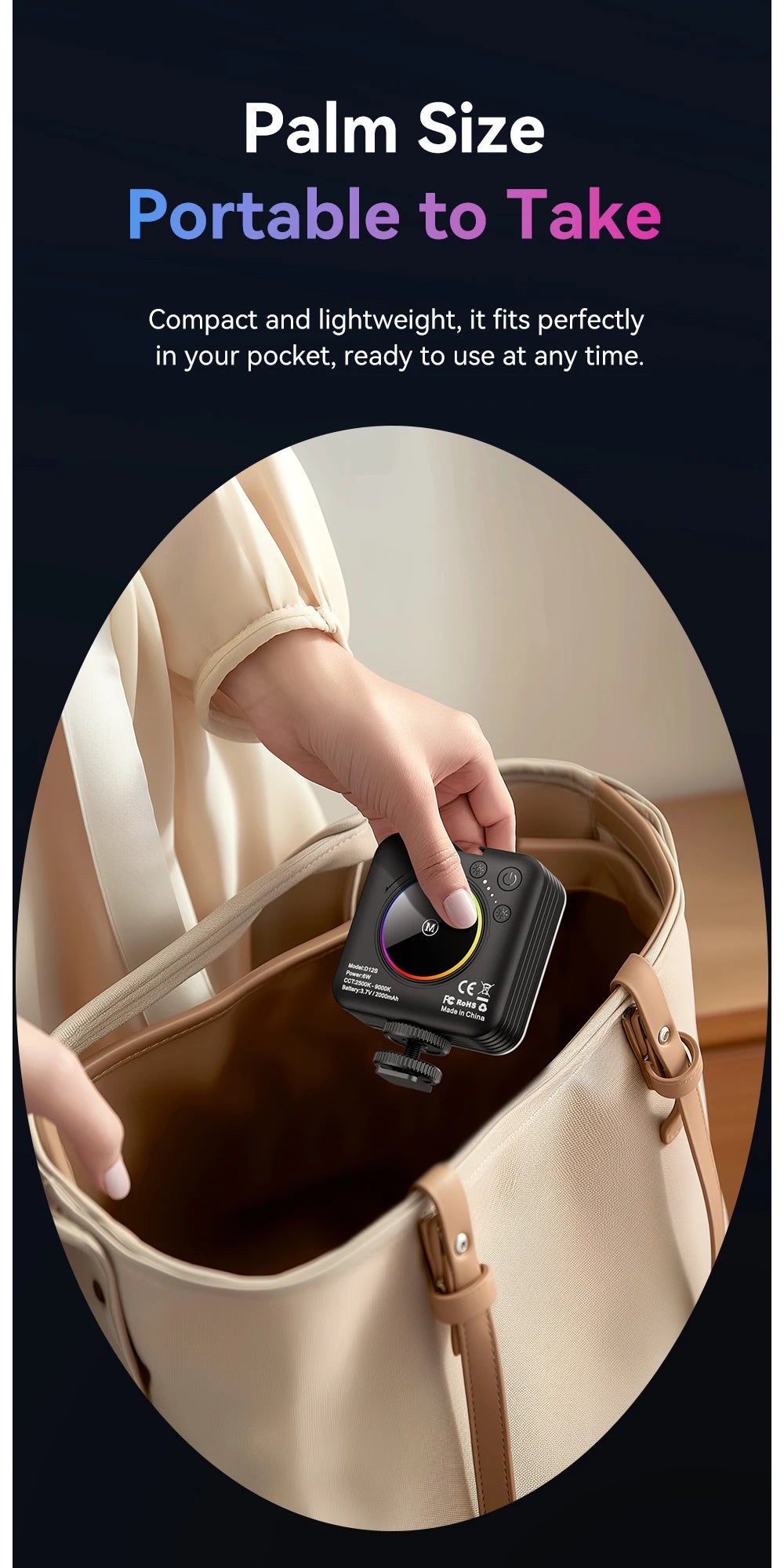 Small, square black LED video light with a circular display, held by a hand to be placed in a tote bag.