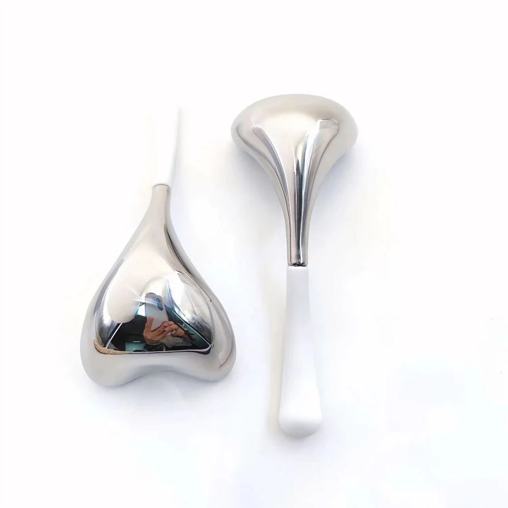 Two heart-shaped, silver stainless steel cryo massage sticks with white handles on a white background.