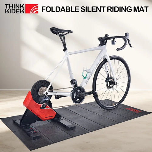 ThinkRider training mat for smart yoga mats, side view of bicycle floor trainer mat under indoor exercise bike.