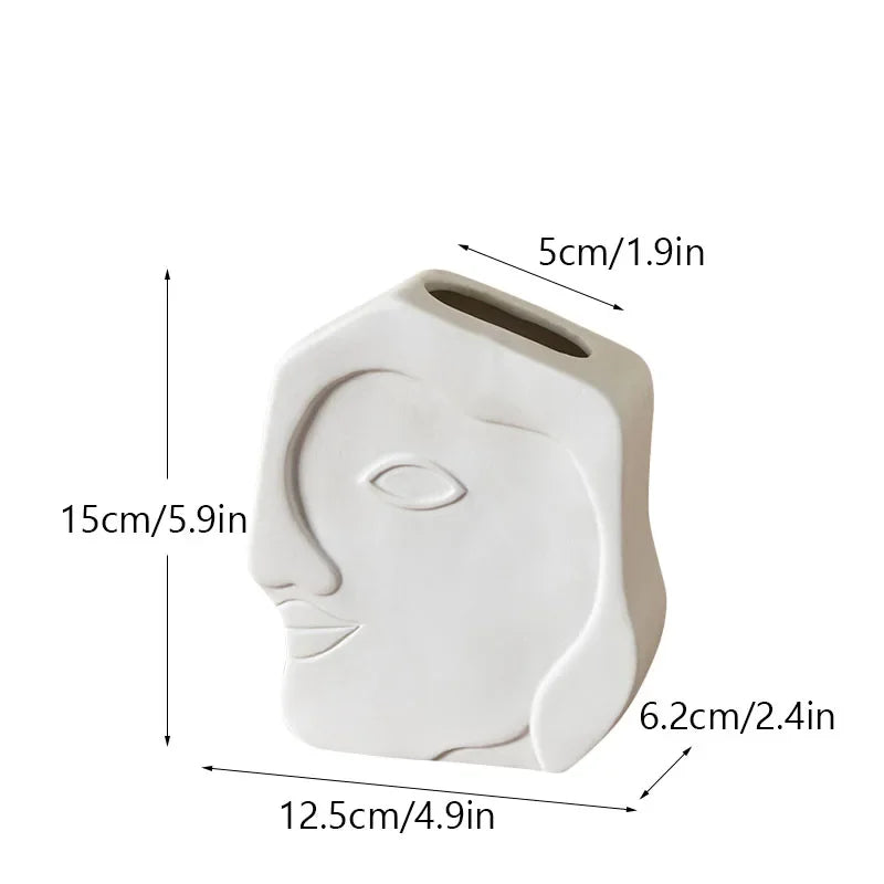 White ceramic face vase with side handle and top spout opening, 15cm height