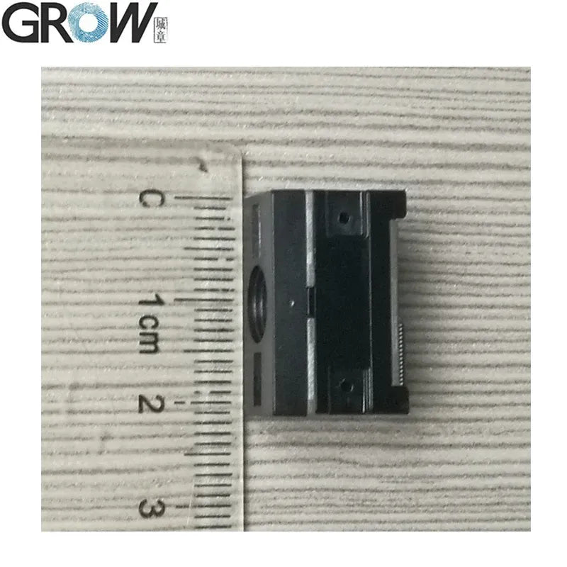 Close-up of barcode scanner optical window with small connector block and size ruler