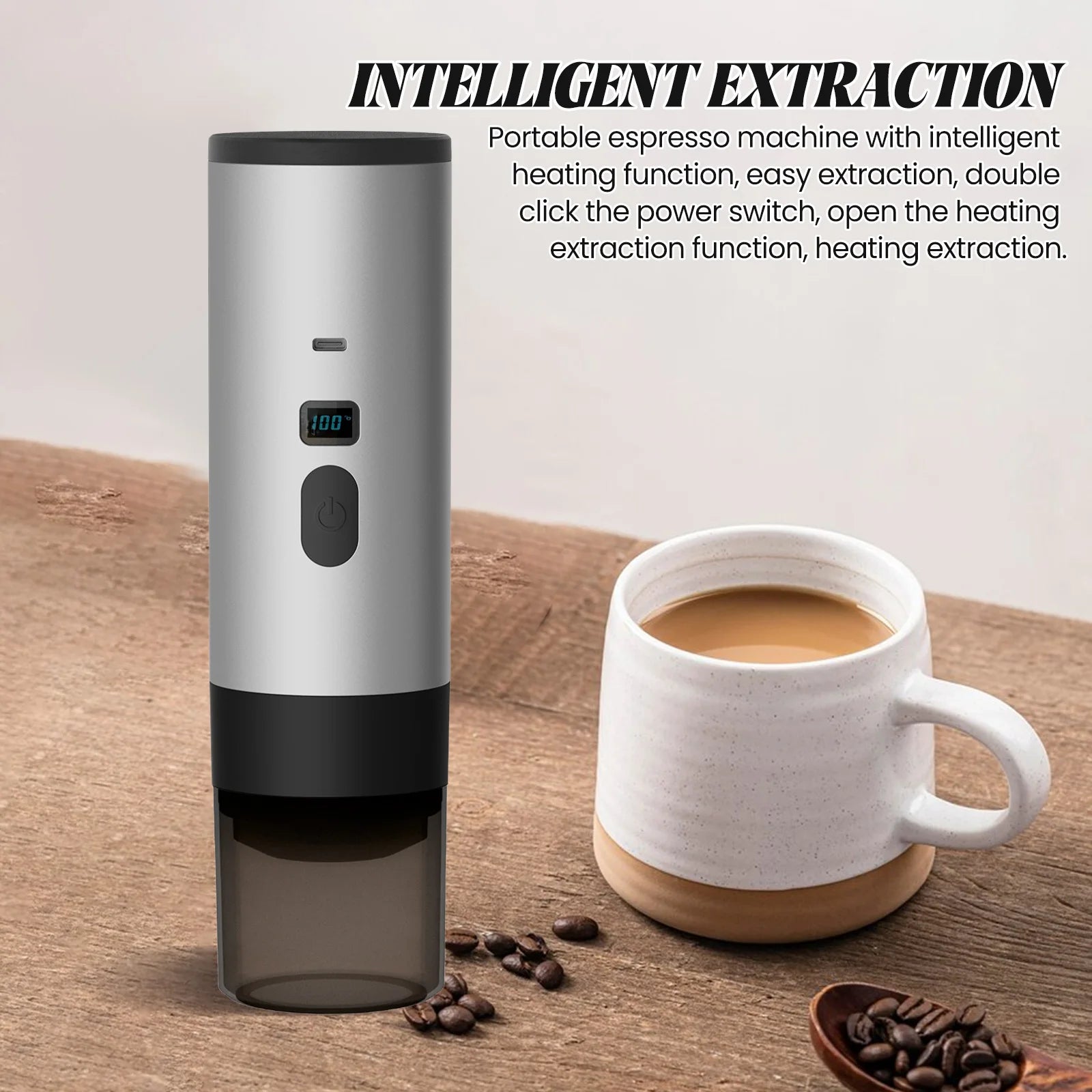 Silver portable espresso machine with heating function and digital display next to a coffee mug on a wooden table.