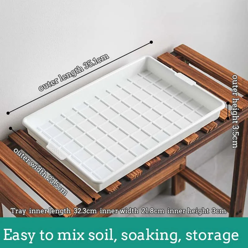 White plastic drainage tray with grid base and water plug opening for window plant pots