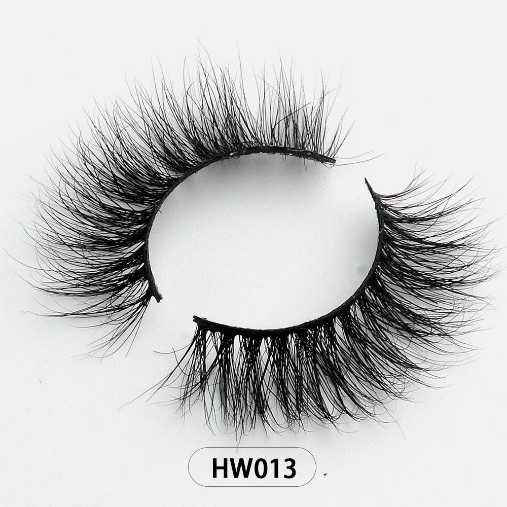 Pair of fluffy black 3D mink false eyelashes on a thin, flexible black band against a white background. Model: HW013.