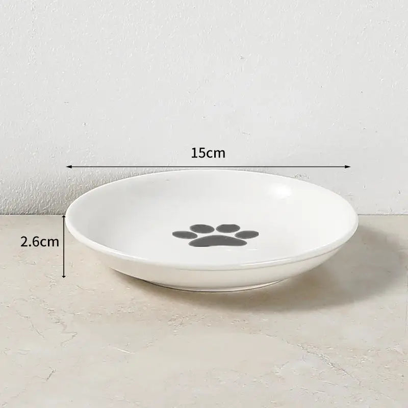 White 15cm ceramic cat and dog bowl with paw print for easy, whisker-friendly feeding and water.