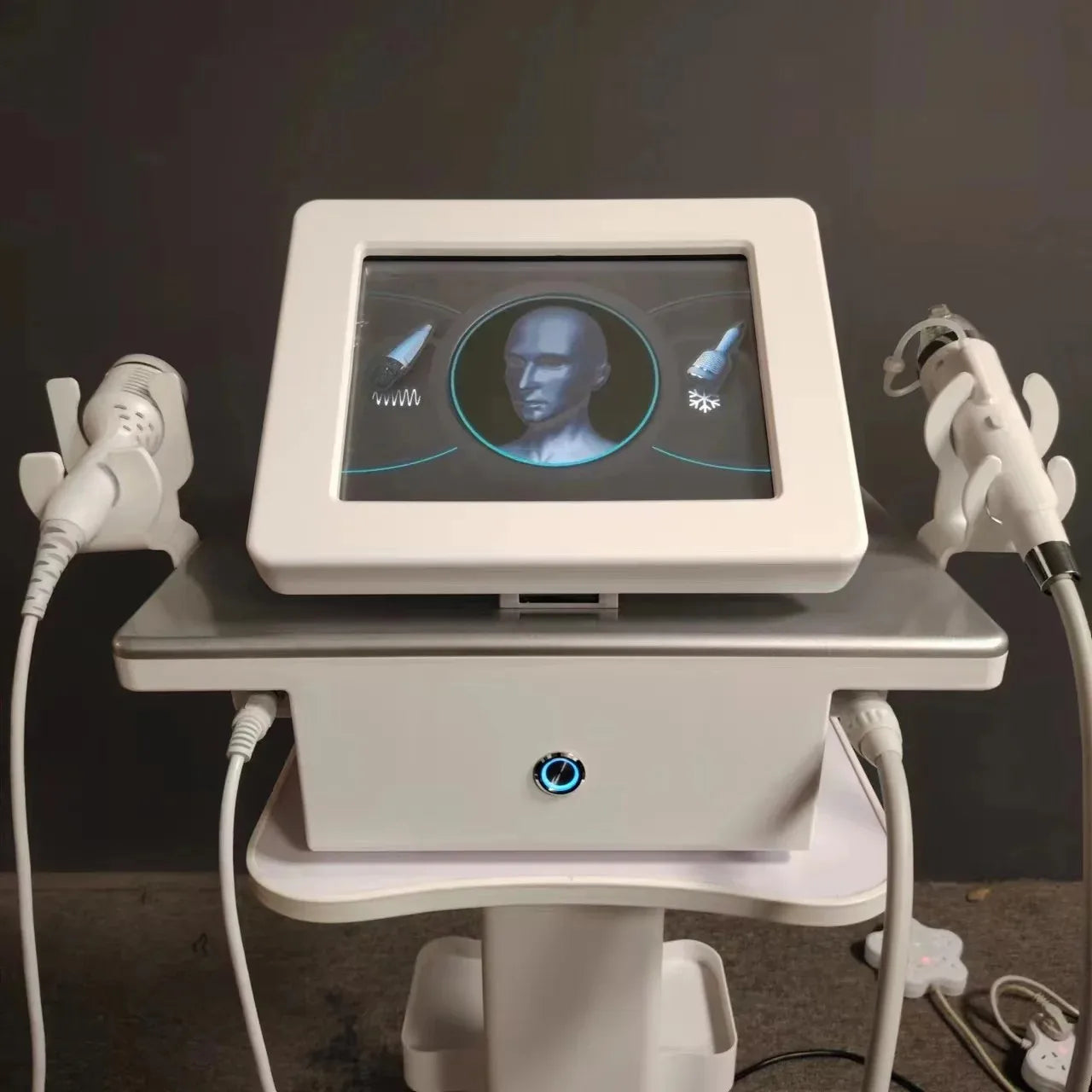 White professional facial machine with touchscreen, two treatment wands, and metal base for skincare procedures.