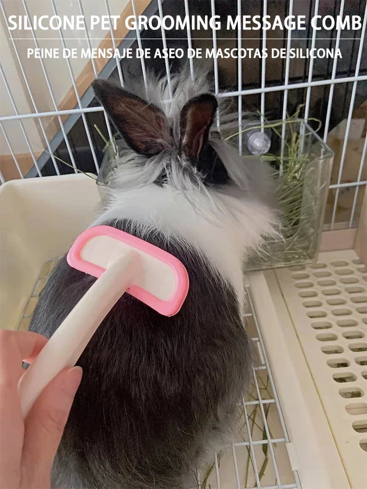 Pink silicone small pet grooming comb gently brushing a rabbit’s fur to remove loose hair and provide a massage.