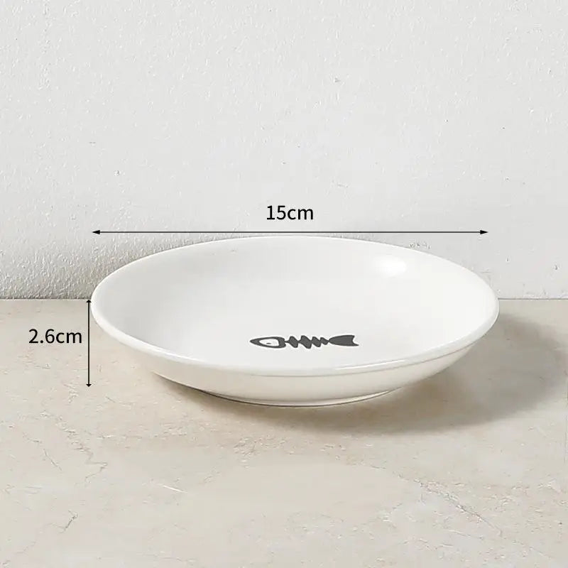 White 15cm ceramic cat bowl with fish bone design for comfortable, shallow feeding of food and water.