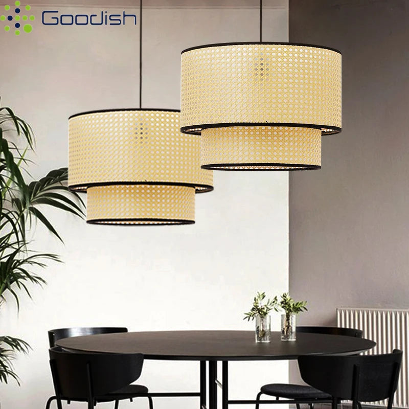Two-tier cylindrical pendant lights made of natural woven rattan with black trim, hanging over a dining table.
