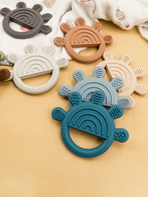 Multi-colored silicone baby teething rings for soothing relief.
